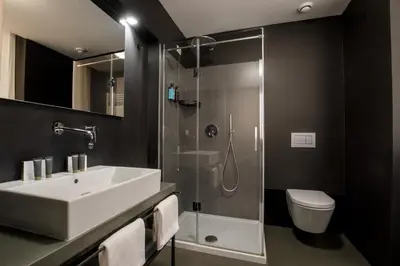a bathroom with a sink and a shower and a toilet at Coronari Palace in Rome