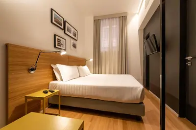 a hotel room with a bed and a table at Coronari Palace in Rome