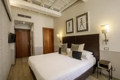 a bedroom with a large white bed in a room at Condotti Palace in Rome
