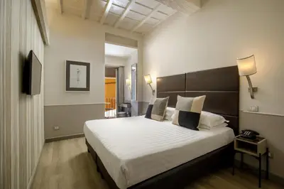 a bedroom with a large bed in a room at Condotti Palace in Rome