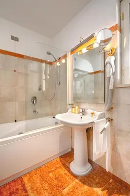 a bathroom with a sink and a bath tub and a sink at Hotel Cinquantatre in Rome