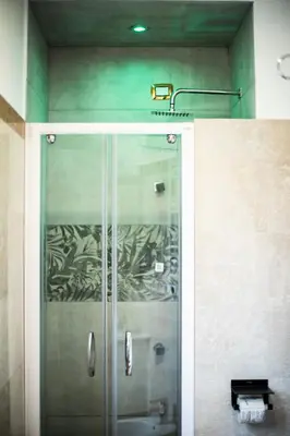 a shower with a glass door in a bathroom at Hotel Cinquantatre in Rome