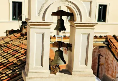 an old bell in a building with an arch at Hotel Cinquantatre in Rome