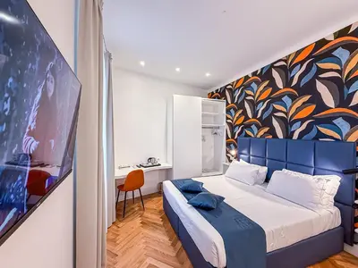 a bedroom with a bed and a painting on the wall at Albergo Abruzzi in Rome