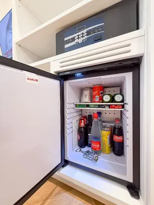 a refrigerator door is open with drinks in it at Albergo Abruzzi in Rome