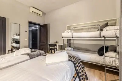 a room with three bunk beds and a desk at Flatinrome Trastevere Complex in Rome