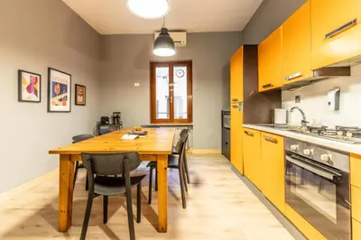 a kitchen with a wooden table and chairs at Flatinrome Trastevere Complex in Rome