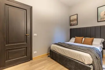 a bedroom with a bed next to a door at Flatinrome Trastevere Complex in Rome