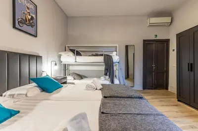a bedroom with two beds with blue pillows at Flatinrome Trastevere Complex in Rome