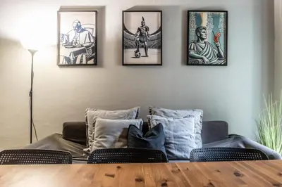 a living room with four pictures on the wall at Flatinrome Trastevere Complex in Rome
