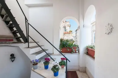 a staircase in a building with potted plants at Flatinrome Trastevere Complex in Rome