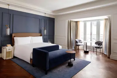a bedroom with a bed and a blue wall at InterContinental Rome Ambasciatori Palace by IHG in Rome