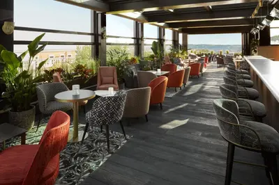 a restaurant with chairs and tables and windows at InterContinental Rome Ambasciatori Palace by IHG in Rome