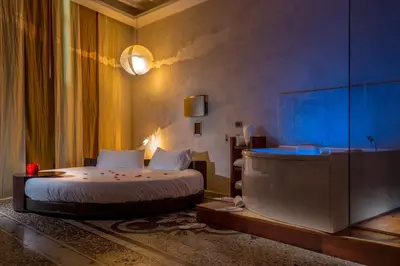 a bedroom with a bed and a tub in a room at SuiteSistina for Brave Lovers in Rome