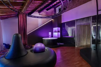 a living room with purple lighting and a bean bag chair at SuiteSistina for Brave Lovers in Rome