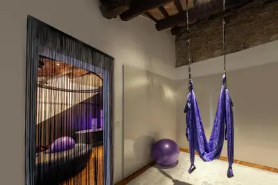 a room with purple decorations hanging from a wall at SuiteSistina for Brave Lovers in Rome