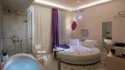 a bathroom with a bed and a tub in a room at SuiteSistina for Brave Lovers in Rome