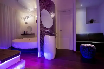 a bathroom with a large mirror and a bed at SuiteSistina for Brave Lovers in Rome