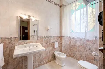 a bathroom with a sink and a toilet at Hotel Artorius in Rome