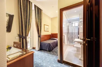 a hotel room with a toilet and a bed at Hotel Artorius in Rome