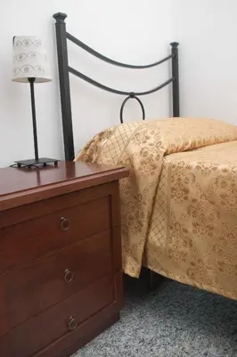 a bedroom with a bed with a dresser and a lamp at Hotel Antico Acquedotto in Rome