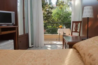 a bedroom with a bed and a view of a balcony at Hotel Antico Acquedotto in Rome