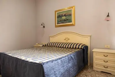 a bedroom with a bed and a picture on the wall at Hotel Ventura in Rome