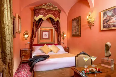 a bedroom with a bed with an ornate headboard at Boutique Hotel Campo de' Fiori in Rome