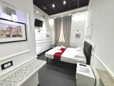 a small room with a bed and a window at L'antica Locanda Dell'Orso in Rome