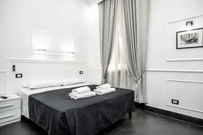 a bedroom with a bed with towels on a table at L'antica Locanda Dell'Orso in Rome