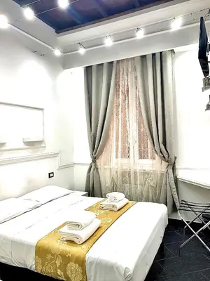 a bedroom with two beds and a window at L'antica Locanda Dell'Orso in Rome