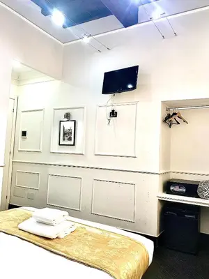 a room with a bed and a tv on the wall at L'antica Locanda Dell'Orso in Rome
