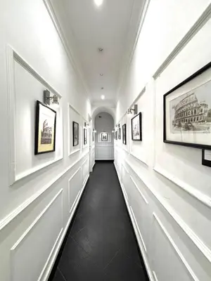 a hallway of a building with paintings on the walls at L'antica Locanda Dell'Orso in Rome