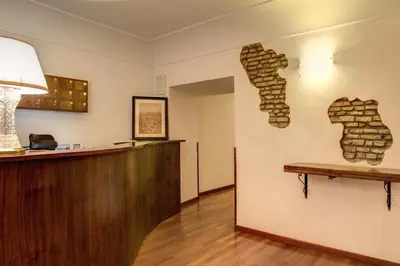 a barber shop with a wall made out of fire bricks at Residenza Domizia in Rome