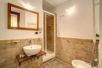a bathroom with a sink and a toilet and a mirror at Residenza Domizia in Rome