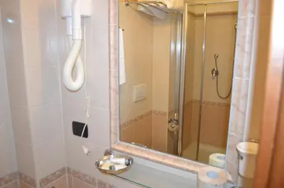 a bathroom with a shower with a mirror and a sink at Dipendenza Hotel Galileo in Rome