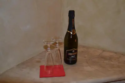 a bottle of wine sitting next to two wine glasses at Dipendenza Hotel Galileo in Rome
