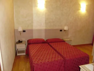 a hotel room with a red bed in a room at Dipendenza Hotel Galileo in Rome