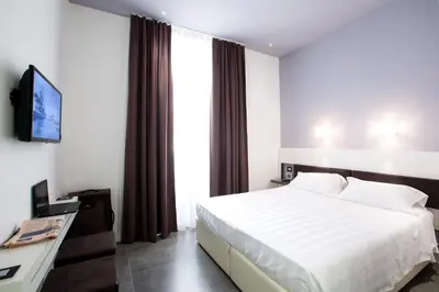 a hotel room with a bed and a television at Crosti Hotel in Rome