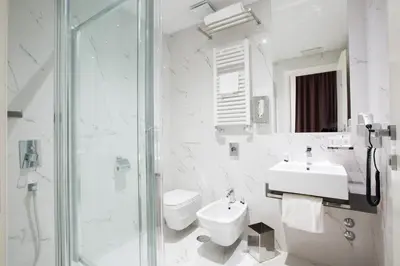 a bathroom with a sink and a toilet and a shower at Crosti Hotel in Rome