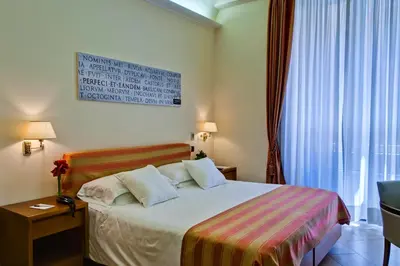 a hotel room with a bed and a window at Crosti Hotel in Rome
