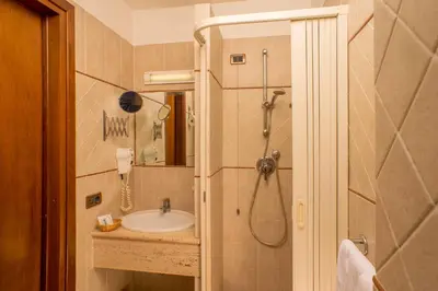 a bathroom with a sink and a shower at Hotel Assisi in Rome