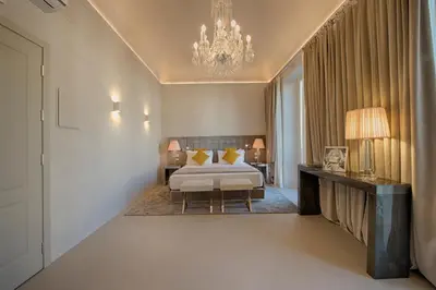 a bedroom with a bed and a chandelier at Palazzo Nainer in Rome