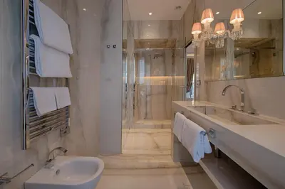 a white bathroom with a sink and a shower at Palazzo Nainer in Rome
