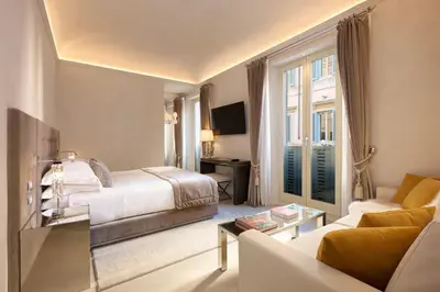 a hotel room with a bed and a couch at Palazzo Nainer in Rome