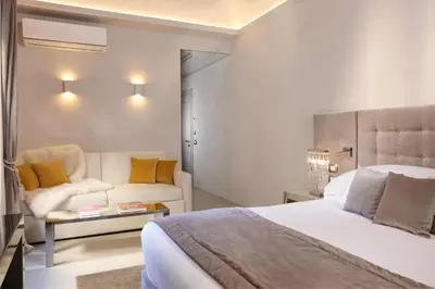 a hotel room with a bed and a couch at Palazzo Nainer in Rome