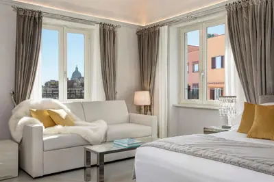 a white living room with a couch and a window at Palazzo Nainer in Rome