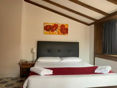 a bedroom with a large bed with white sheets at Suite Artis Barberini in Rome