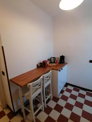 a small kitchen with a wooden table and chairs at Casa Vacanze Colosseo da Fernando no elevator in Rome