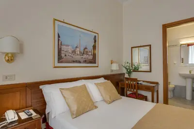 a bedroom with a white bed and a telephone at Hotel Silla in Rome
